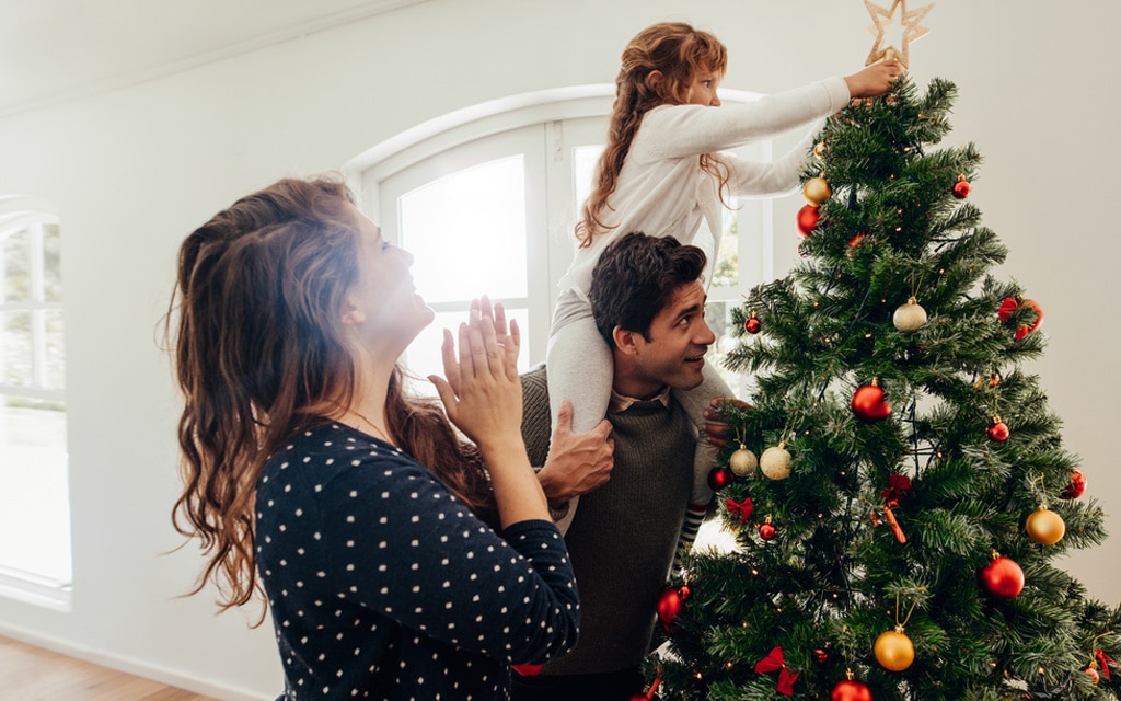 Family around Christmas tree