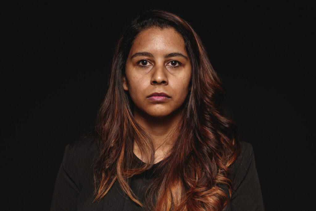 woman looks at the camera while discussing addiction in marginalized communities