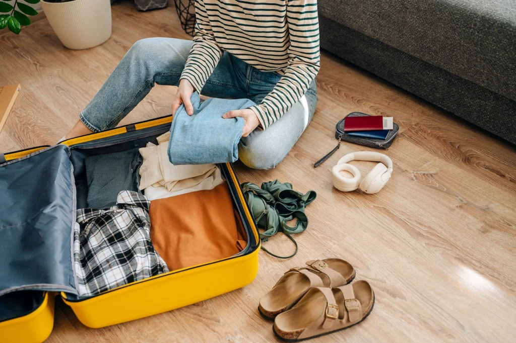 Packing a suitcase with clothing items