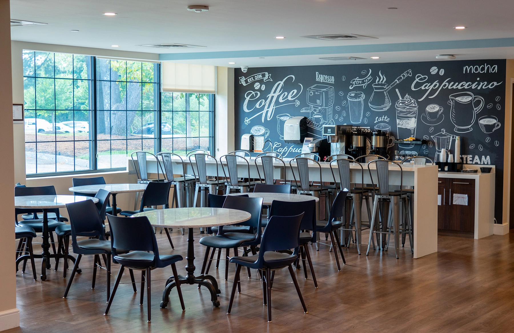 Modern caf&eacute; with seating and coffee