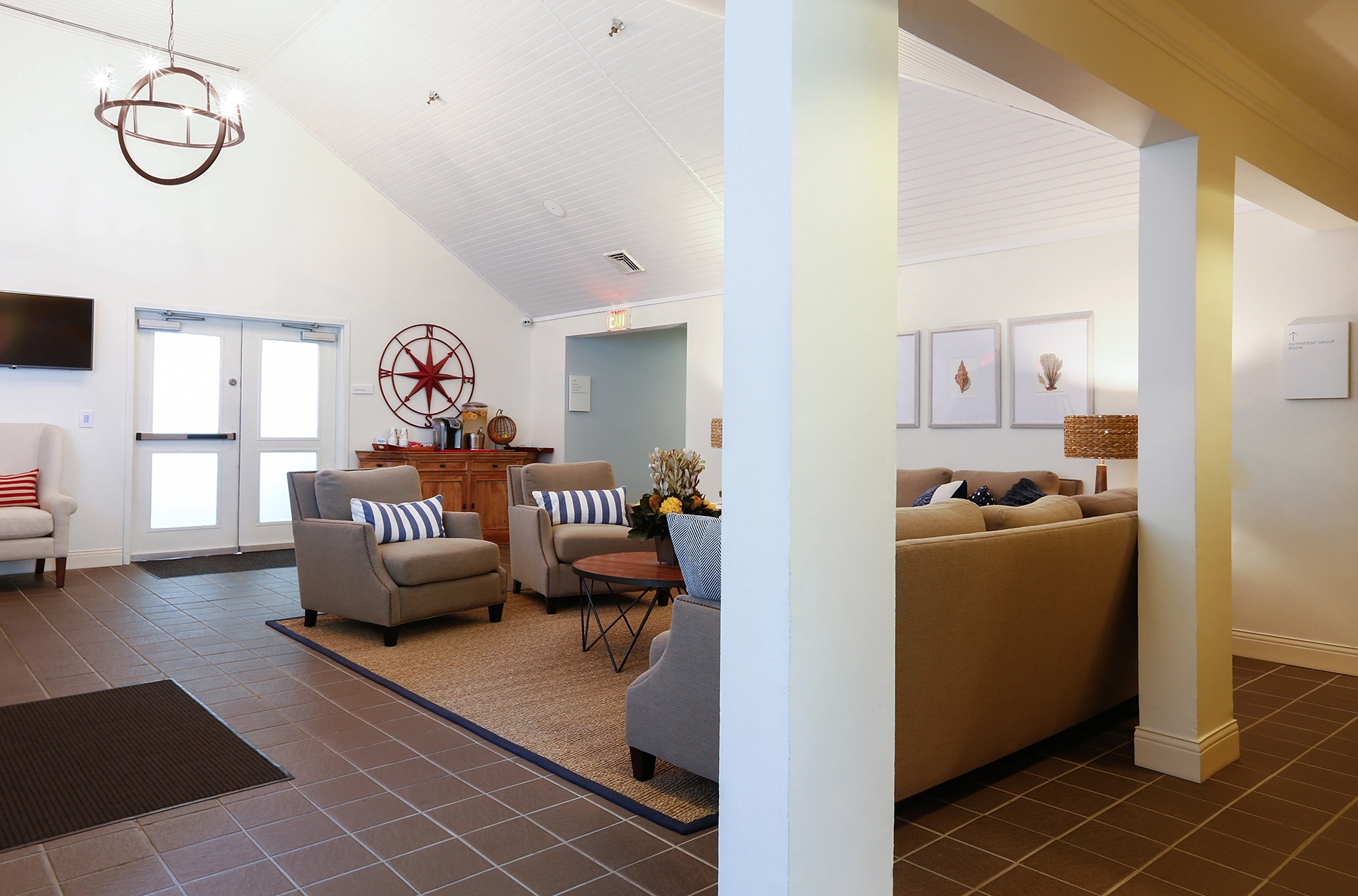 Entry lounge at Lighthouse with armchairs and nautical decor