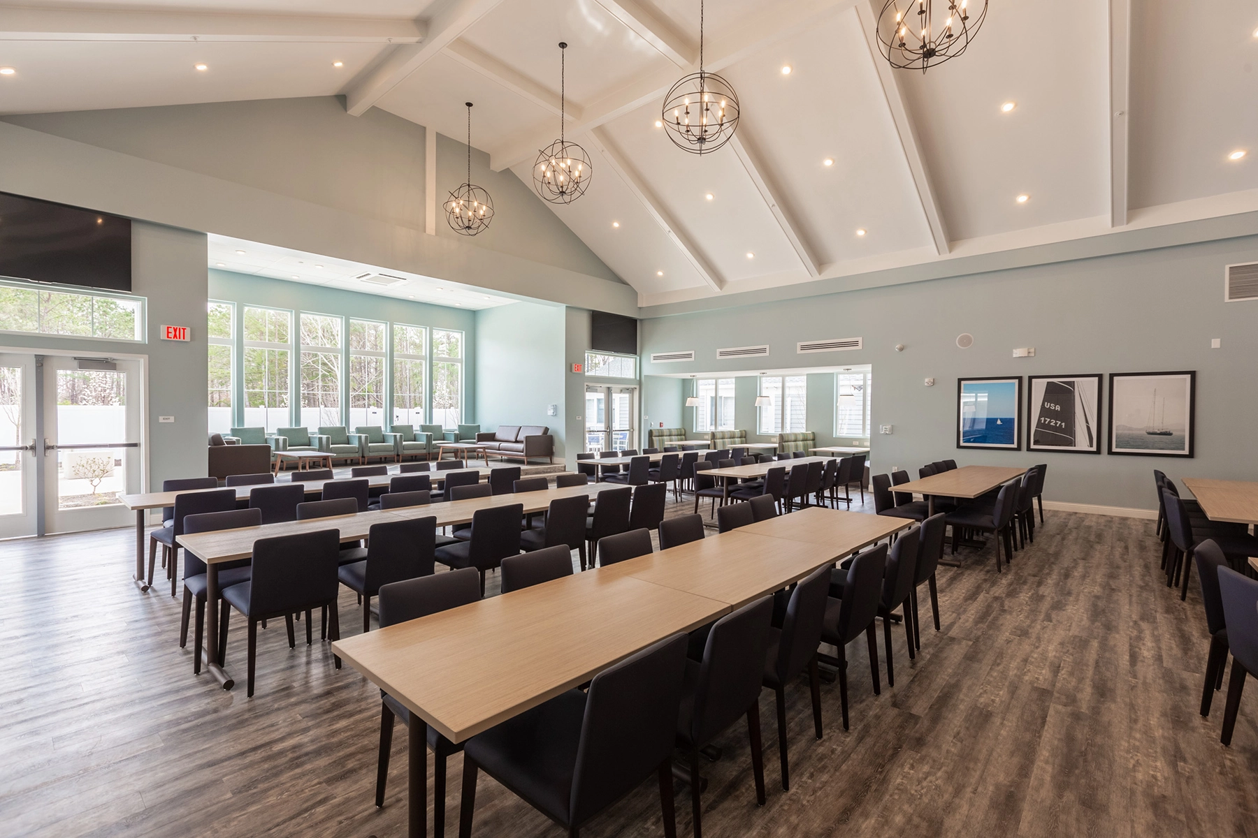 Large dining hall at Lighthouse with long tables and pendant lights