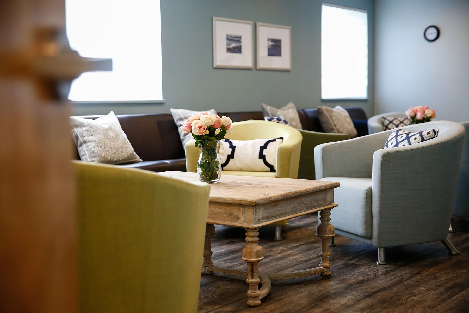 Sitting area at Lighthouse with armchairs, a sofa and a wooden coffee table