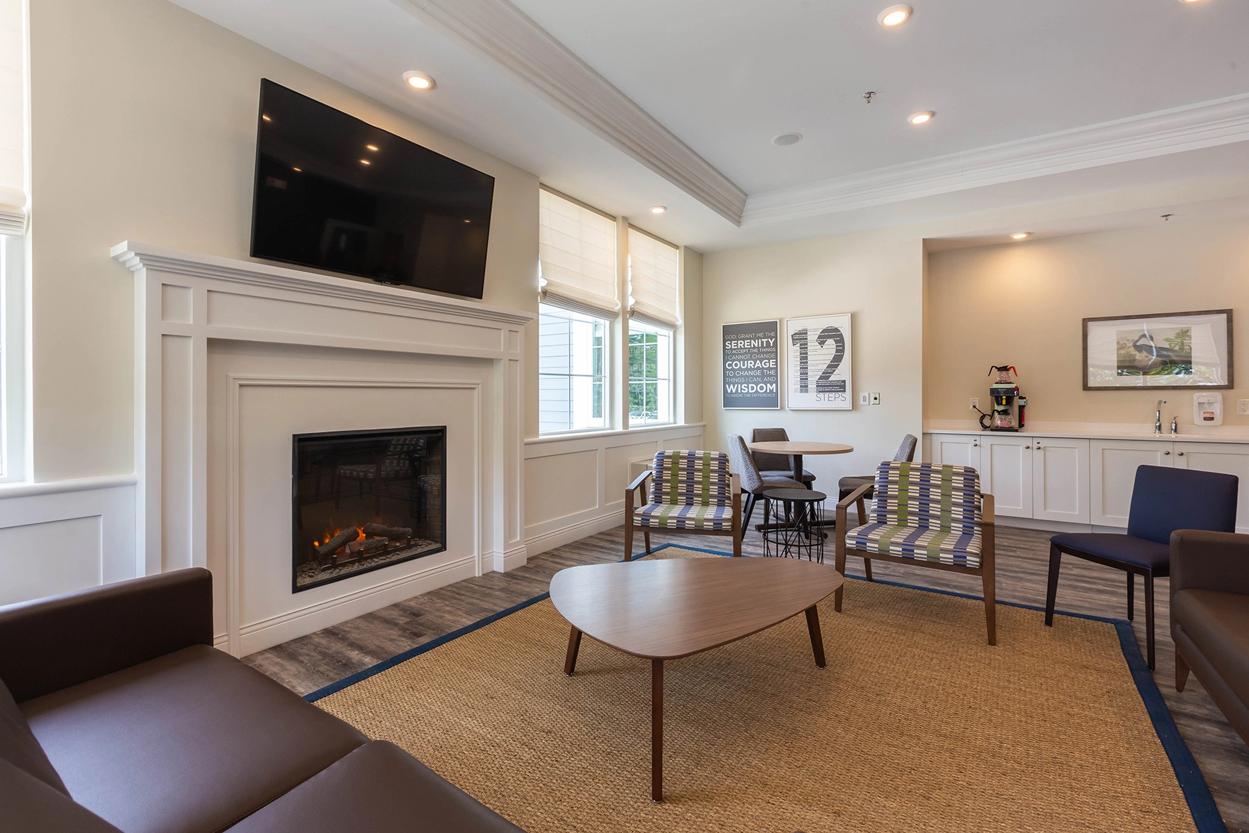 Lounge at Lighthouse with a fireplace, TV and 12-step wall art