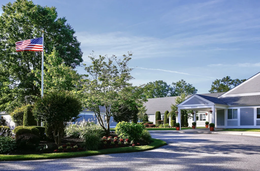 Tree-lined driveway and American flag at the Lighthouse treatment facility