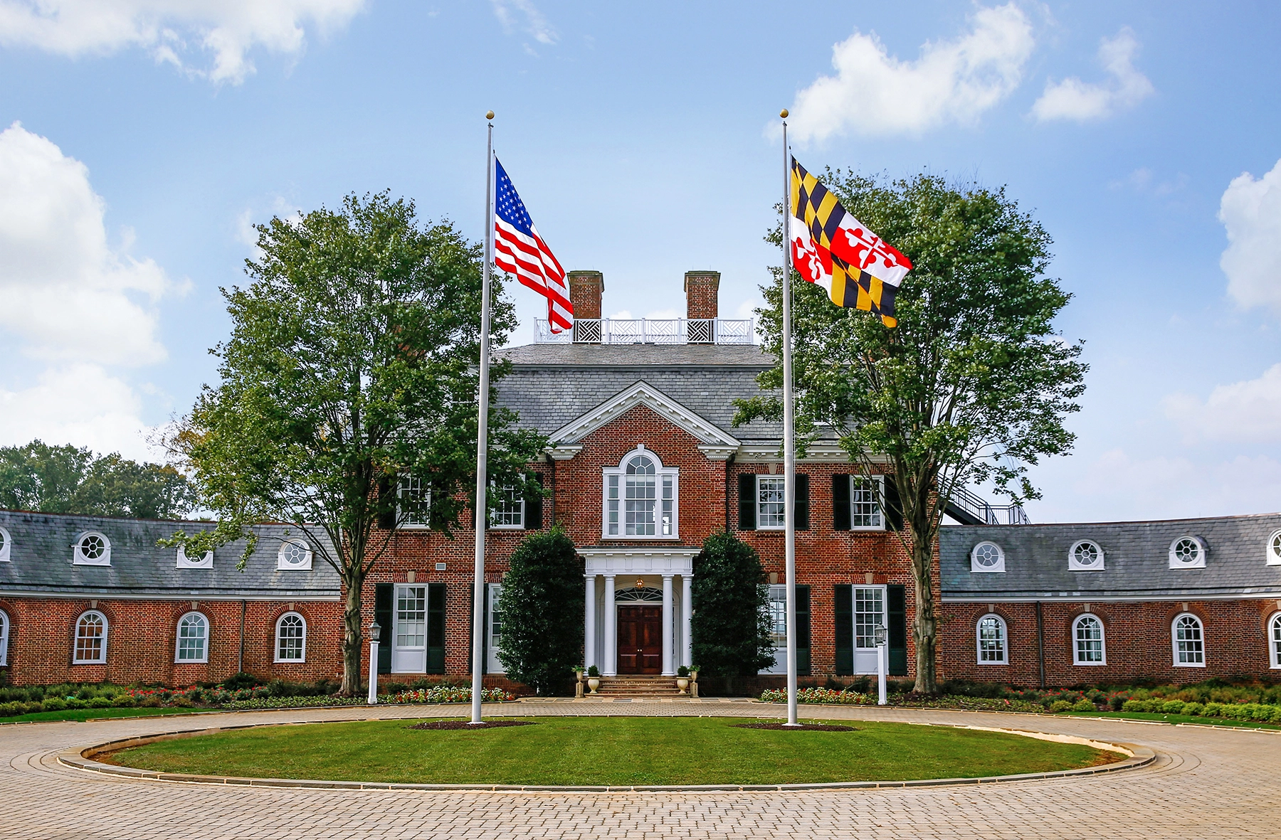 Elegant brick mansion with flags