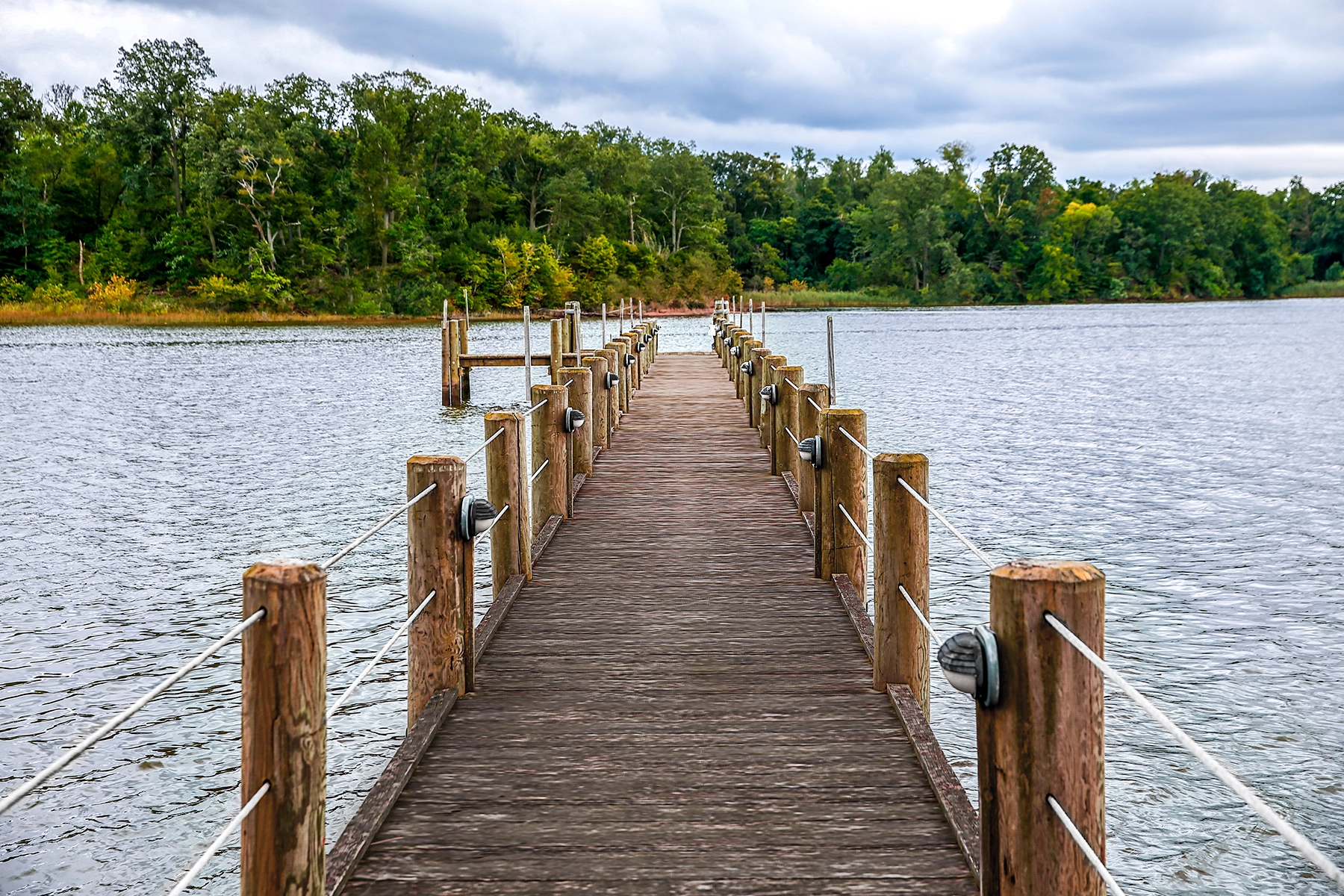 Wooden pier extending over calm water