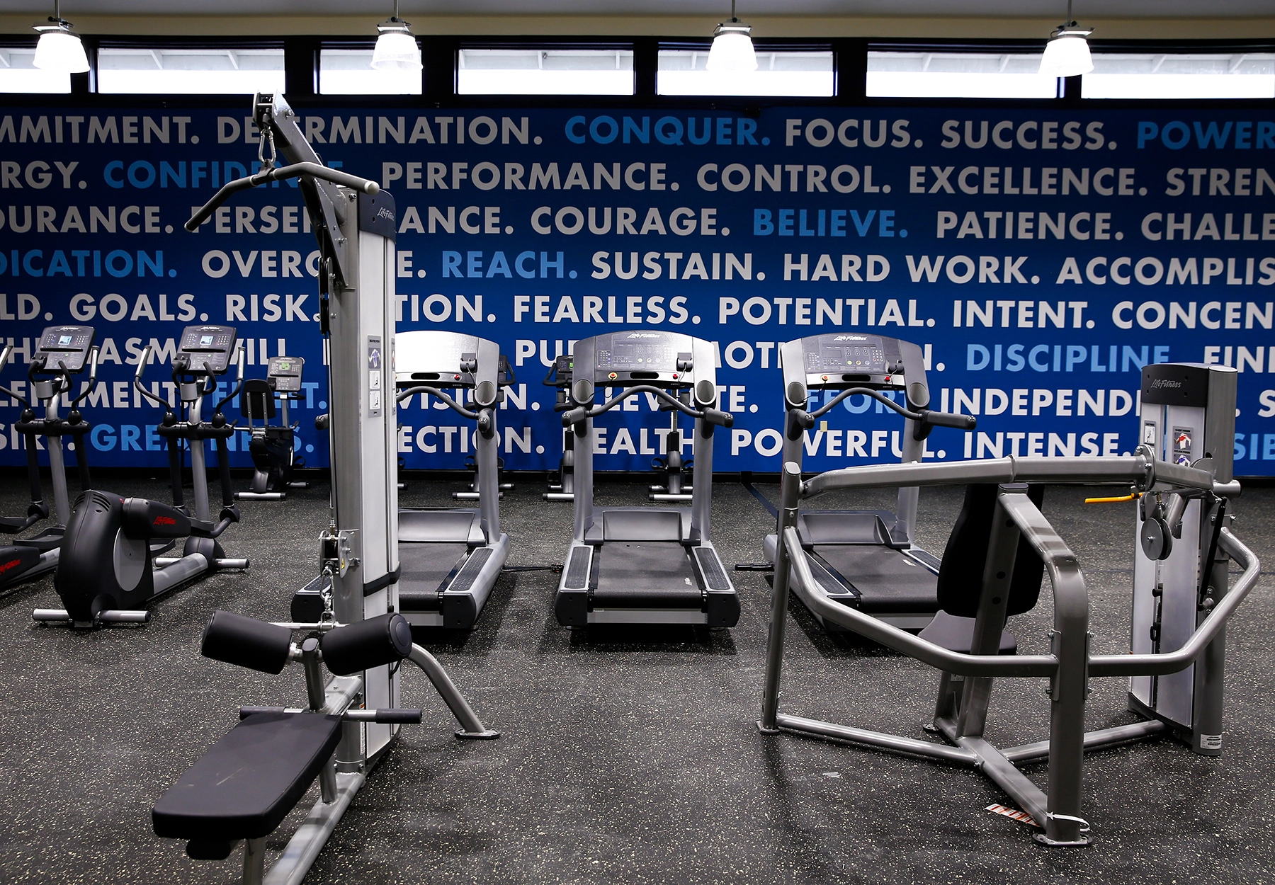 Gym equipment with motivational wall text